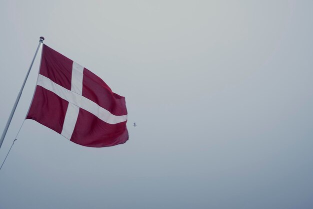 Low angle shot of a Danish flag blowing in the wind on a chilly day