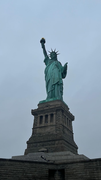 Low-angle shot of the statue of liberty against the sky background, New York City, USA