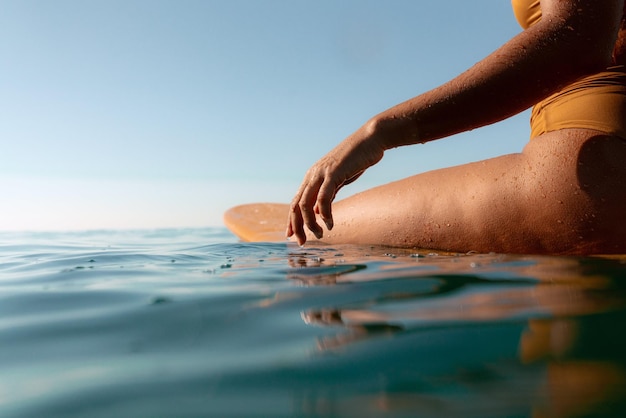 Low Angle Shot of a Woman Wearing a Yellow Swimsuit Bathing in the Sea Water Photo
