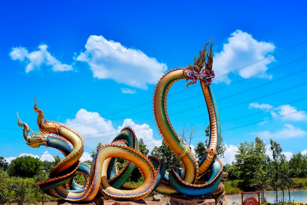 Low angle twin stucco painted as a large serpent at pra kai keaw wang nakin udon thani thailand