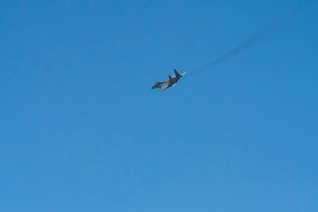 Low angle view of airplane against clear blue sky