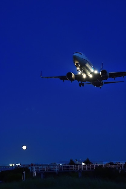 Low angle view of airplane against clear blue sky