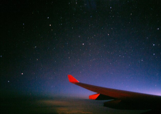 Low angle view of airplane against sky at night