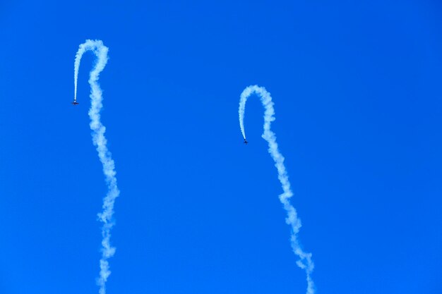 Low angle view of airplane flying against blue sky