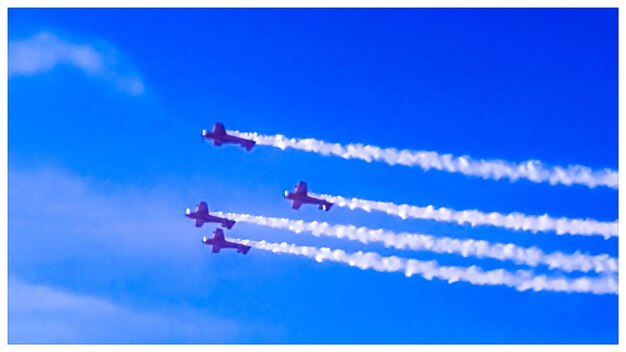 Low angle view of airplane flying against blue sky