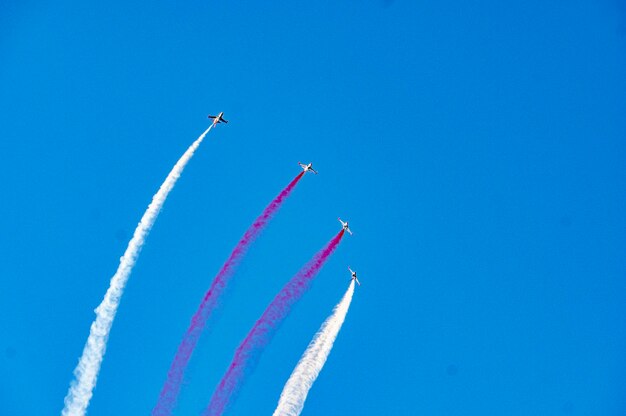 Low angle view of airplane flying against blue sky