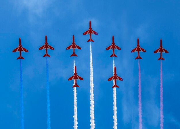 Low angle view of airplane flying against blue sky