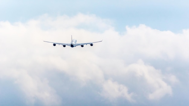 Low angle view of airplane flying against cloudy sky
