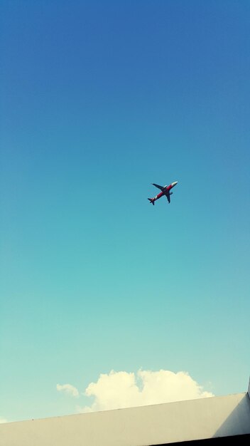 Low angle view of airplane flying in sky