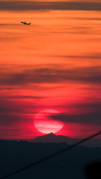 Low angle view of airplane wing at sunset