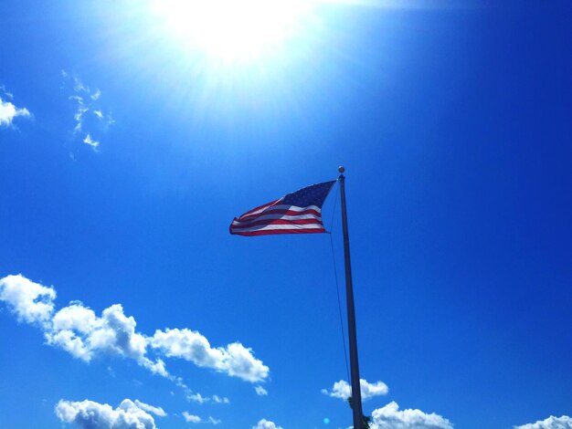 Low angle view of american flag against cloudy sky