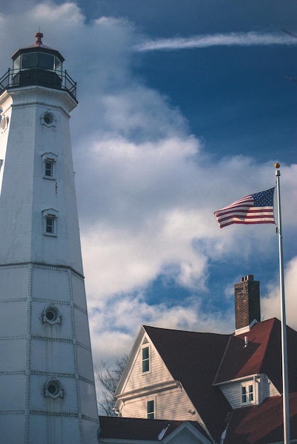 low angle view of american flag against light house