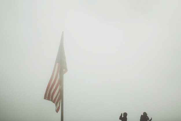 Photo low angle view american flag in foggy weather