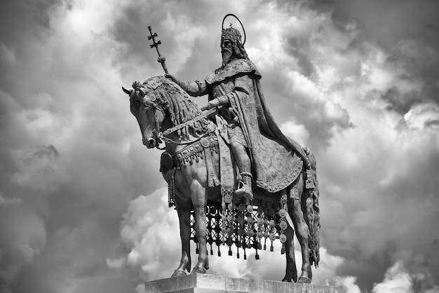 Low angle view of angel statue against cloudy sky