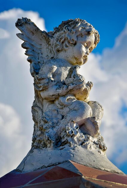 Low angle view of angel statue against sky