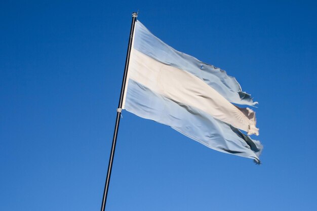 Low angle view of argentina flag against clear blue sky