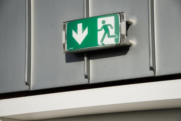 Low angle view of arrow sign on wall