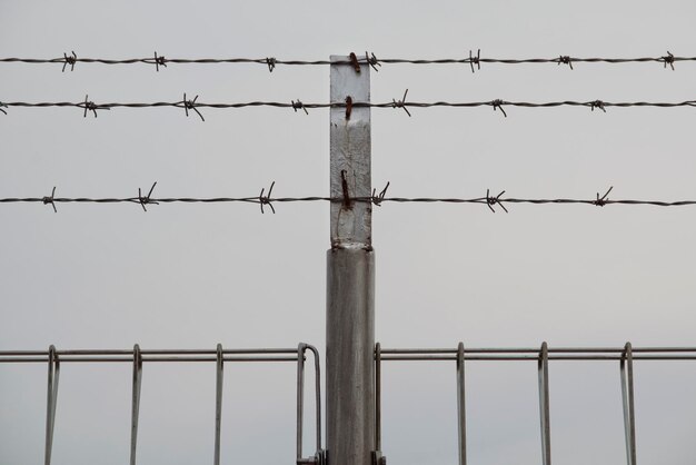 Low angle view of barbed wire against clear sky