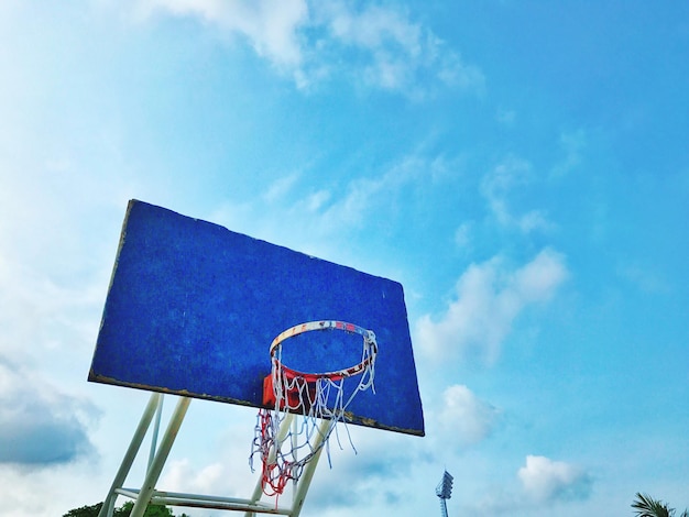 Low angle view of basketball hoop against blue sky