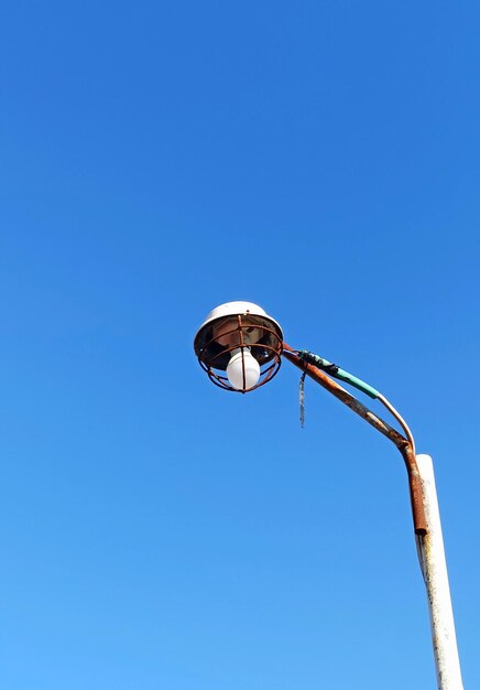 Low angle view of basketball hoop against blue sky