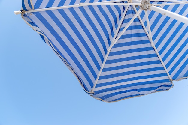 low angle view of beach umbrella against clear blue sky