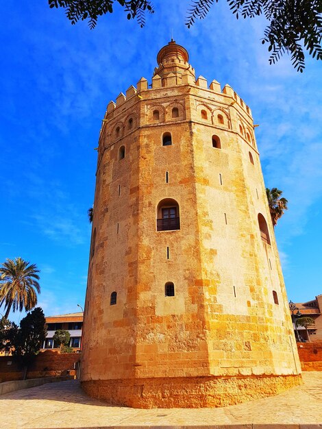 Low angle view of bell tower against blue sky