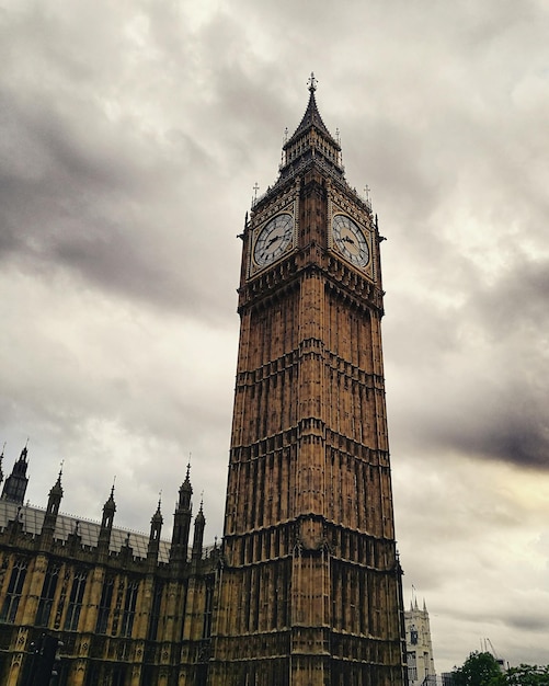 low angle view of big ben against cloudy sky