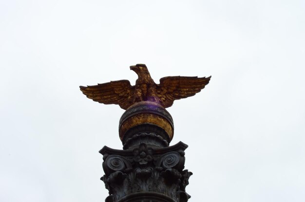 Low angle view of bird sculpture against clear sky