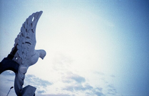 Low angle view of bird statue against the sky