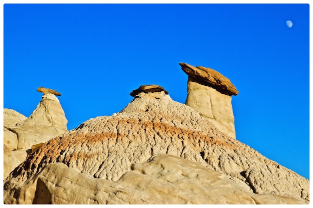 Low angle view of birds on building against blue sky