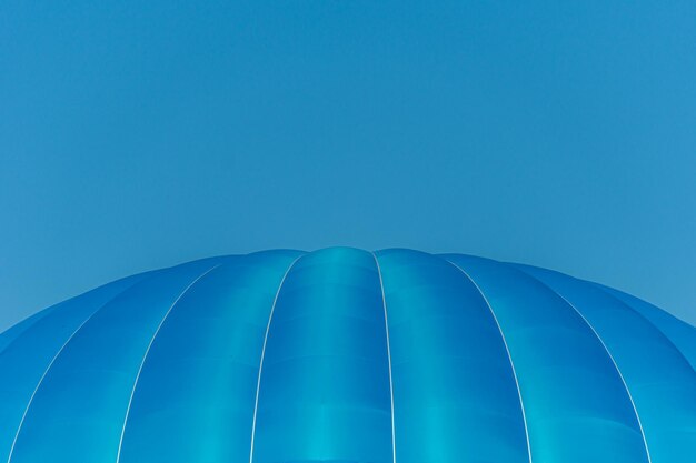 Low angle view of blue hot air balloon against blue sky