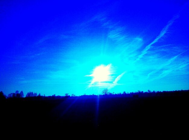 Low angle view of blue sky over field