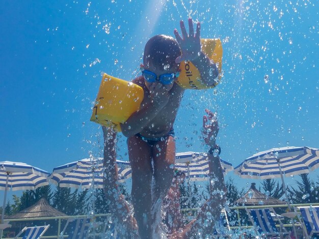 Low angle view of boy swimming in pool