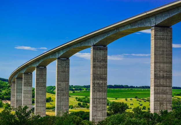 Low angle view of bridge against blue sky