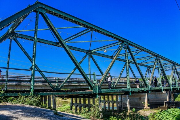 Low angle view of bridge against clear blue sky