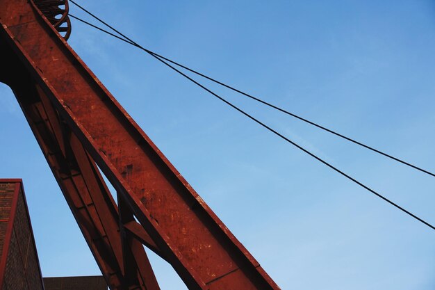 Low angle view of bridge against clear blue sky