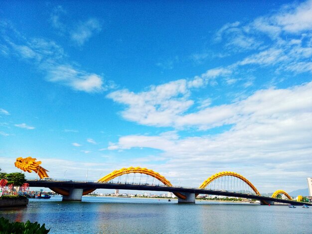 Low angle view of bridge over river against sky