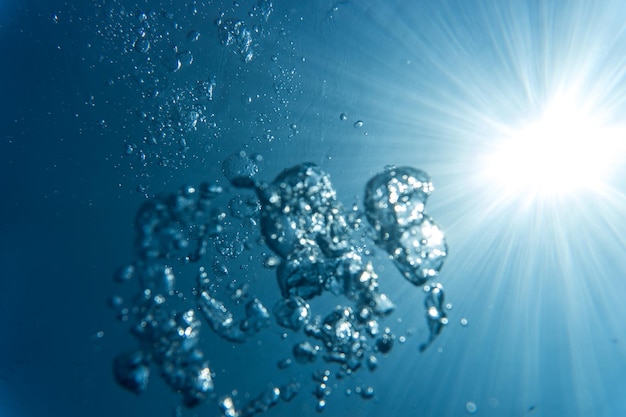 Low angle view of bubbles in sea on sunny day