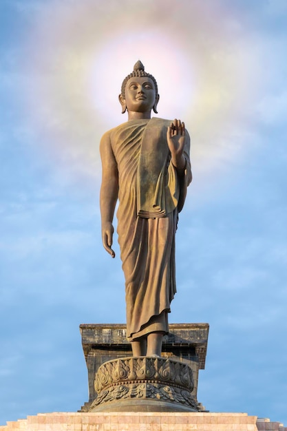 Low angle view of buddha statue against sky