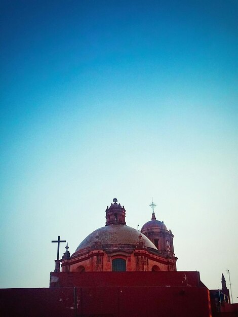 Low angle view of building against clear blue sky