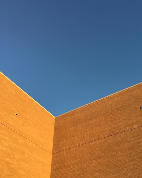 Low angle view of building against clear blue sky