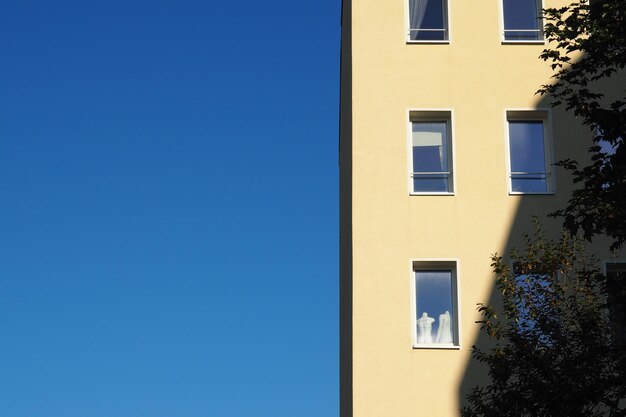 Low angle view of building against clear blue sky