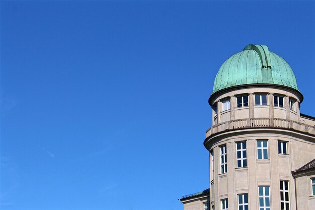 Low angle view of building against clear blue sky