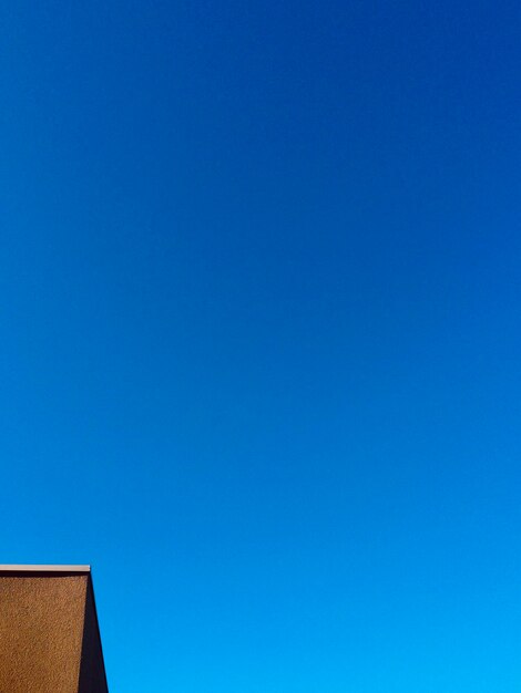 Low angle view of building against clear blue sky