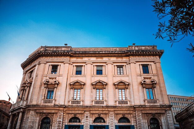 Low angle view of building against clear blue sky