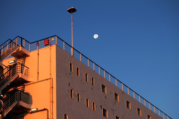 Low angle view of building against clear blue sky