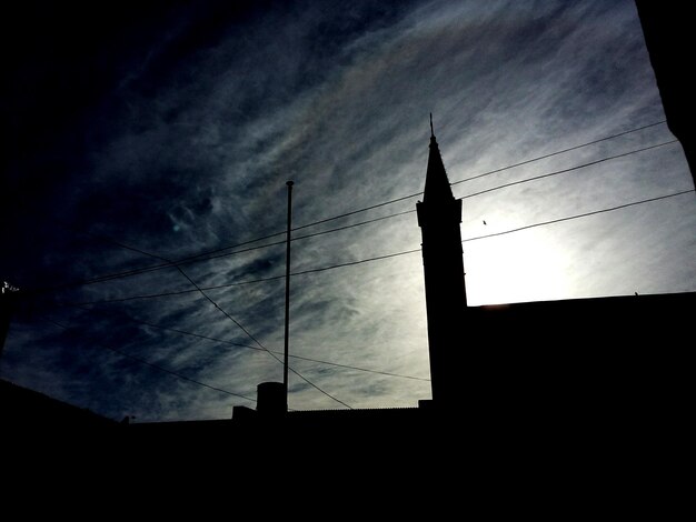 Low angle view of building against cloudy sky