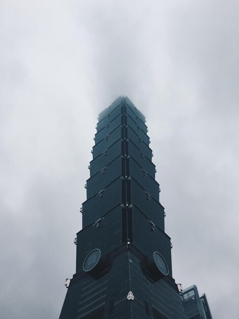 low angle view of building against cloudy sky