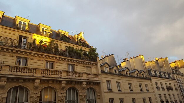 Low angle view of building against cloudy sky