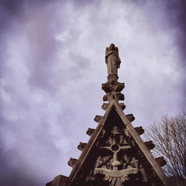 Low angle view of building against cloudy sky